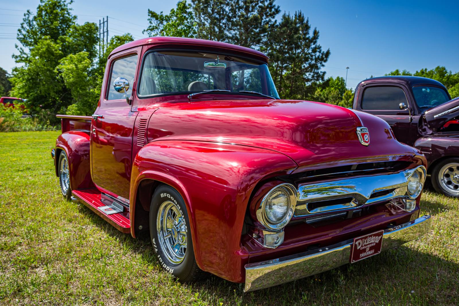 Candy red 1956 Ford F-100 pickup at a car show